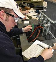 Student experimenting in chemistry lab.
