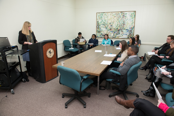 Female student speaking to a group in a conference room