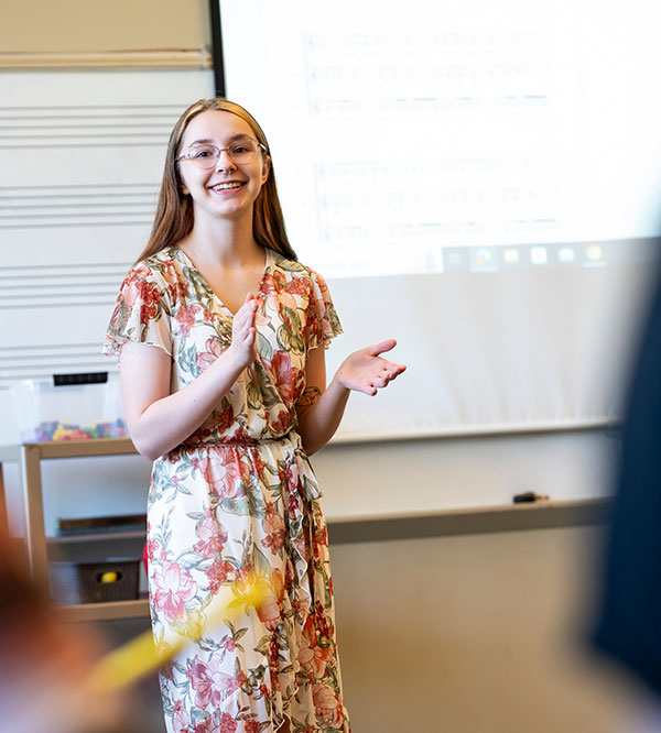 a student clapping out a rhythm in front of a class