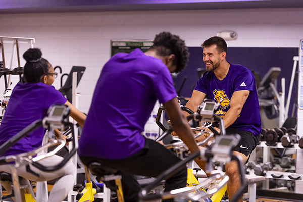 students working out on stationary bicycles