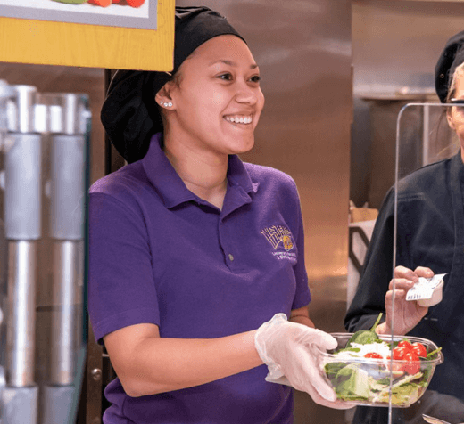 Employee handing over a salad